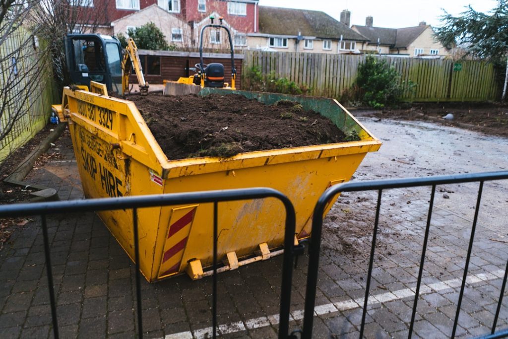 a-large-yellow-dump-truck-filled-with-dirt-ovyz1a5jhzy