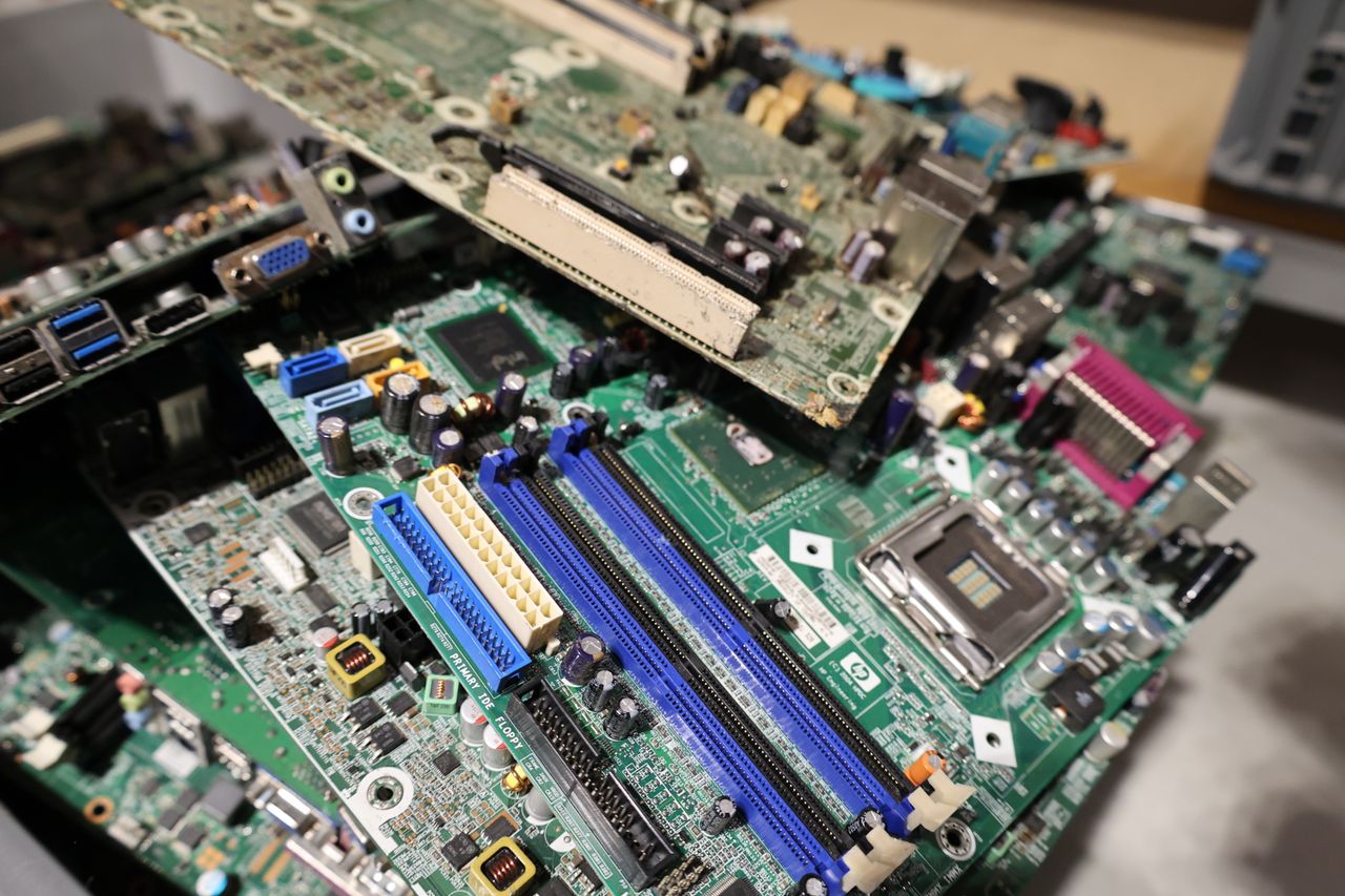 Close-up of stacked circuit boards illustrating e-waste recycling and technology management.